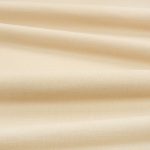 Tessuto Linara di Romo nella colorazione Butterbean drappeggiato, per mostrarne la caduta e la finitura spazzolata.