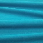 Tessuto Linara di Romo nella colorazione Verditer drappeggiato, per mostrarne la caduta e la finitura spazzolata.
