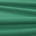 Tessuto Linara di Romo nella colorazione Malachite drappeggiato, per mostrarne la caduta e la finitura spazzolata.