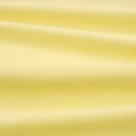 Tessuto Linara di Romo nella colorazione Daffodil drappeggiato, per mostrarne la caduta e la finitura spazzolata.