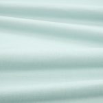 Tessuto Linara di Romo nella colorazione Aqua drappeggiato, per mostrarne la caduta e la finitura spazzolata.