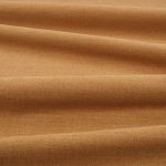 Tessuto Linara di Romo nella colorazione Copper drappeggiato, per mostrarne la caduta e la finitura spazzolata.