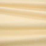Tessuto Linara di Romo nella colorazione Flax drappeggiato, per mostrarne la caduta e la finitura spazzolata.