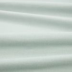 Tessuto Linara di Romo nella colorazione Mineral drappeggiato, per mostrarne la caduta e la finitura spazzolata.