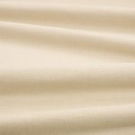 Tessuto Linara di Romo nella colorazione Limestone drappeggiato, per mostrarne la caduta e la finitura spazzolata.