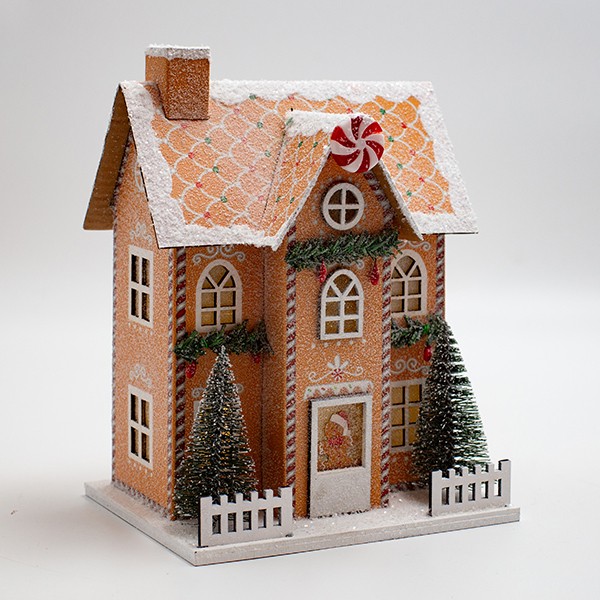 Casetta di Natale luminosa in carta beige con caramelle, fotografia del produttore: gli altri oggetti eventualmente presenti nella scena non sono compresi
