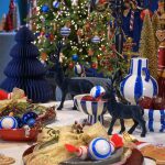 Albero di Natale honeycomb in carta blu notte alto 15 cm in un allestimento natalizio; gli altri oggetti della scena non sono compresi