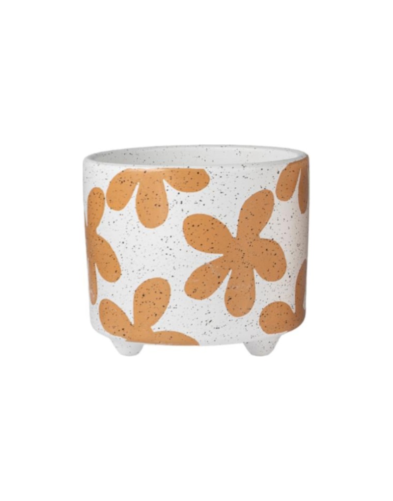 Cachepot in ceramica bianca punteggiata con fiori stilizzati color terracotta, su tre piedini
