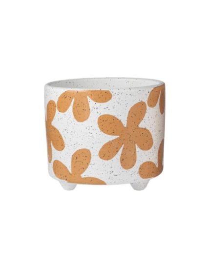 Cachepot in ceramica bianca punteggiata con fiori stilizzati color terracotta, su tre piedini