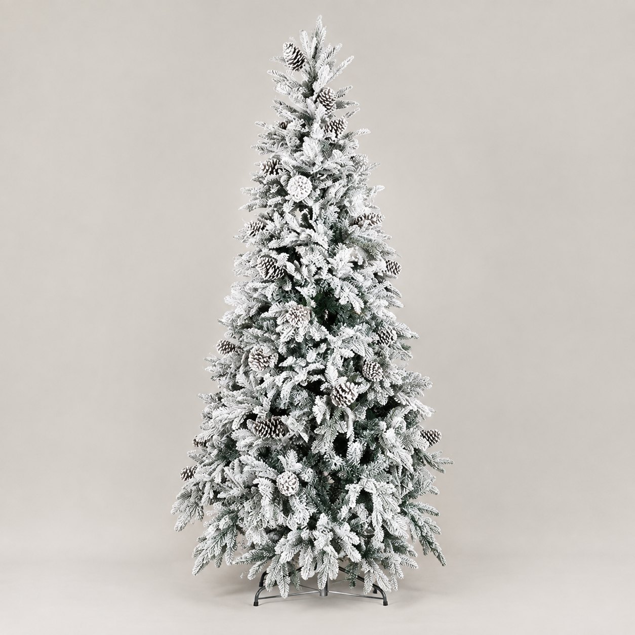 Albero di Natale innevato Reykjavik 210 cm — vista intera Albero di Natale artificiale Reykjavik alto 210 cm, fittamente innevato di bianco con pigne applicate tra i rami, montato su base a croce in metallo e fotografato su fondo neutro